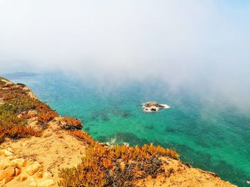 High angle view of rocks on sea