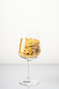 Close-up of wine in glass against white background