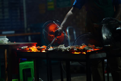 Grilled oyster at jakarta food streets vendor. sizzling on a grill,
