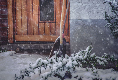 Person standing on snow covered house