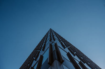 Low angle view of modern building against clear blue sky