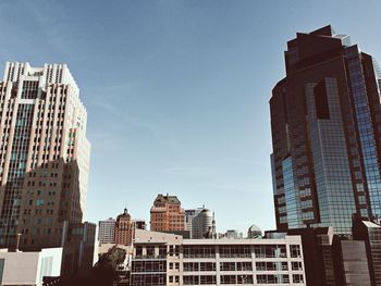 Low angle view of buildings in city against sky