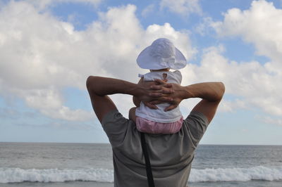 Woman holding camera in sea
