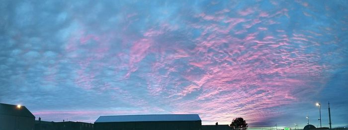 Low angle view of buildings against sky during sunset