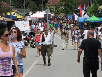 Group of people walking on road in city