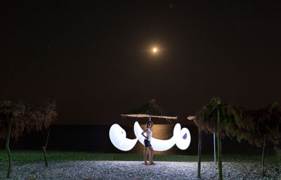 High angle view of man and woman against moon at night