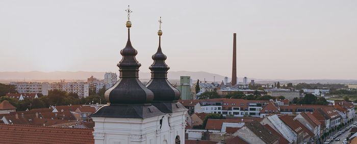 Buildings in city against clear sky