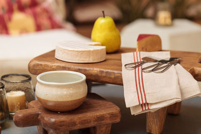 Close-up of cheese and pear with napkin on cutting board