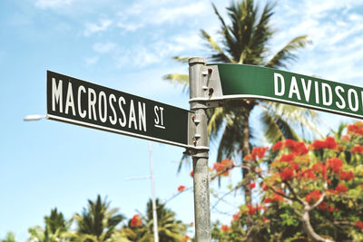 Low angle view of road sign against sky