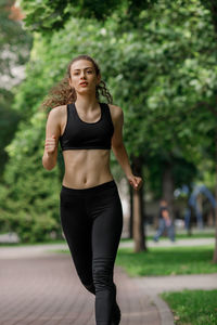 Young woman running at park