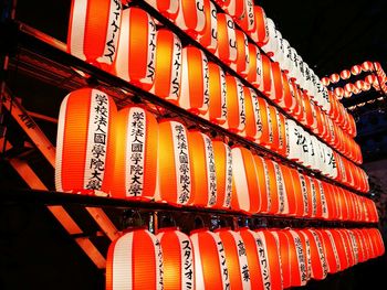 Low angle view of illuminated lanterns hanging at night