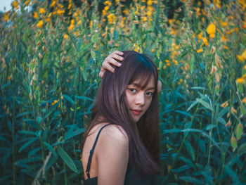 Portrait of beautiful young woman lying down on land