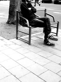 Low section of man walking on street