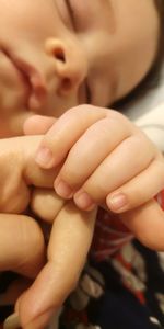 Close-up of baby boy sleeping on bed