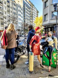 Rear view of people walking in city