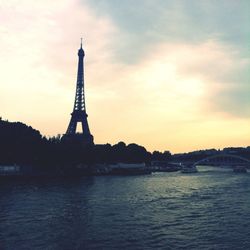 Silhouette of eiffel tower against sky at sunset