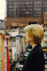 Portrait of woman looking at city