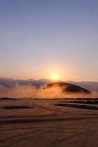 Scenic view of desert against sky during sunset