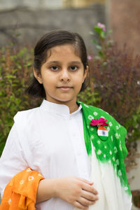 Portrait of a smiling girl standing outdoors