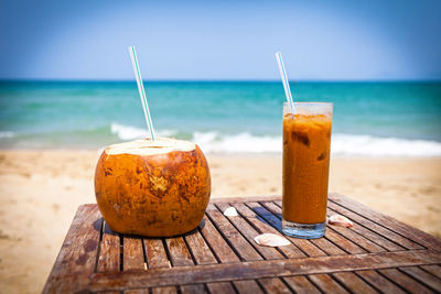 Close-up of drink on beach