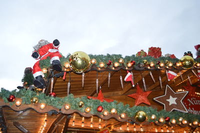 Low angle view of christmas lights against sky