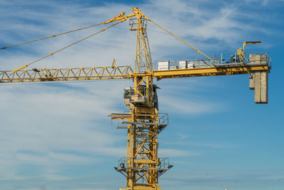 Tower crane against the blue sky. building under construction. industrial skyline