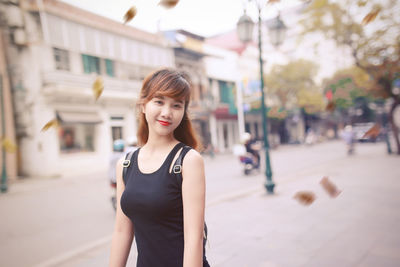 Portrait of smiling beautiful woman wearing black dress