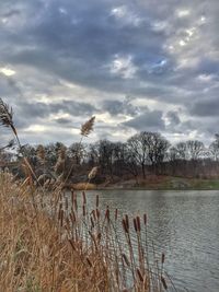 Scenic view of lake against cloudy sky