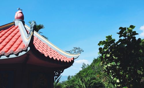 Low angle view of traditional building against blue sky