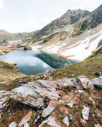 Lake on transfagarasan with snowy ridges and reflection