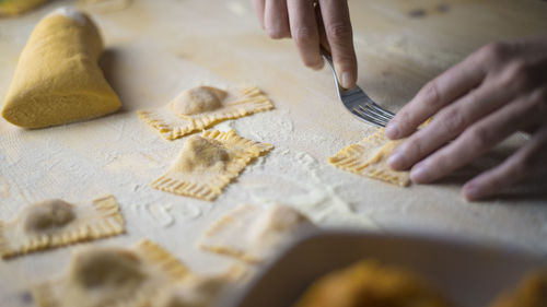 Cropped image of woman preparing food on table