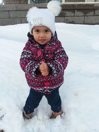 Portrait of cute girl standing in snow