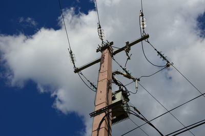 Low angle view of telephone pole against sky