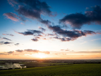 Scenic view of landscape against cloudy sky