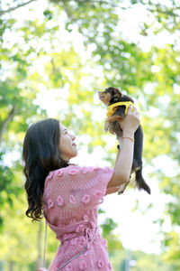 Rear view of woman against birds