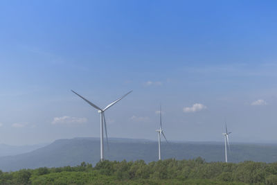 Windmill on field against sky