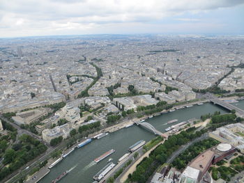 High angle view of cityscape by river against sky