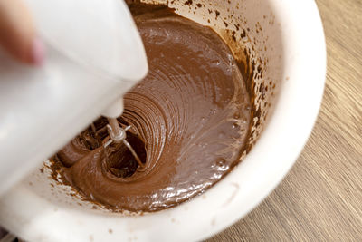 Mixing the dough with a hand mixer with a whisk with melted butter added, the dough is thick  mass.