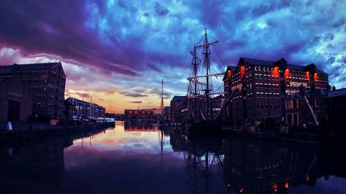 Reflection of buildings in water at sunset