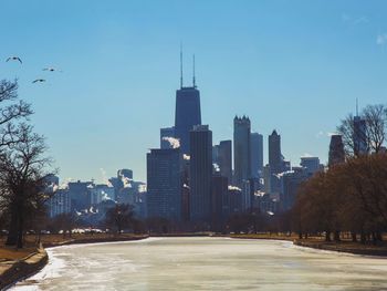 Frozen pond in lincoln park against sky