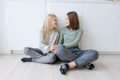 Young woman sitting on sofa at home