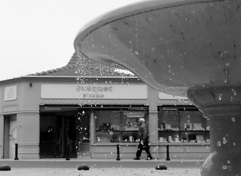 People in front of building against clear sky