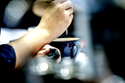 Midsection of man using mobile phone