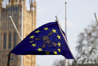 Low angle view of flag against built structure