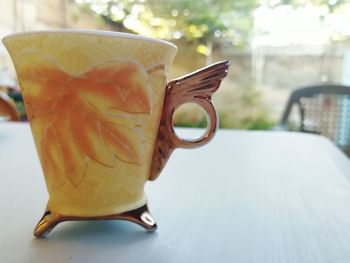 Close-up of coffee cup on table