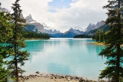 Scenic view of lake and mountains against sky