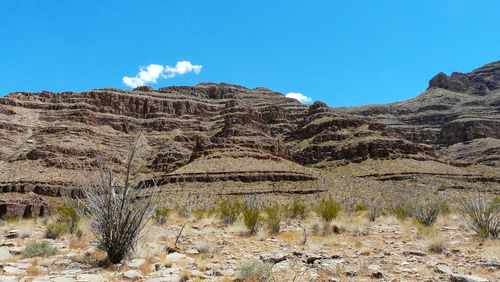 Scenic view of mountains against clear blue sky