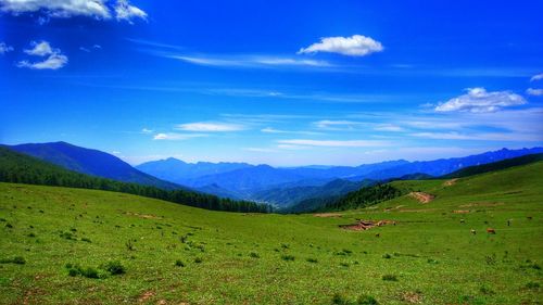 Scenic view of mountains against cloudy sky