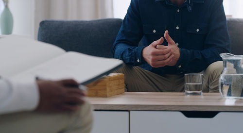 Midsection of man working at home