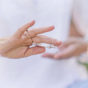 Midsection of woman holding crystal